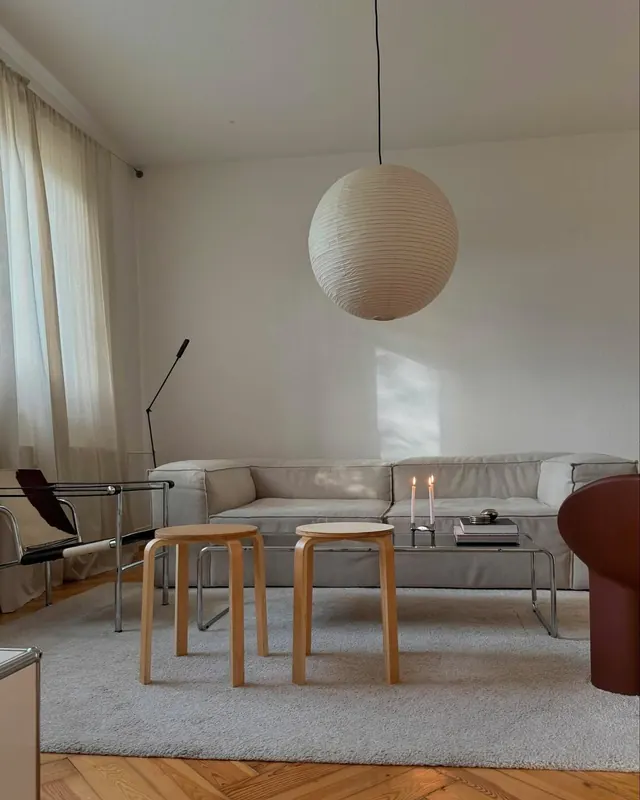 Minimalist living room with sculptural pendant, minimal, light-mode, muted