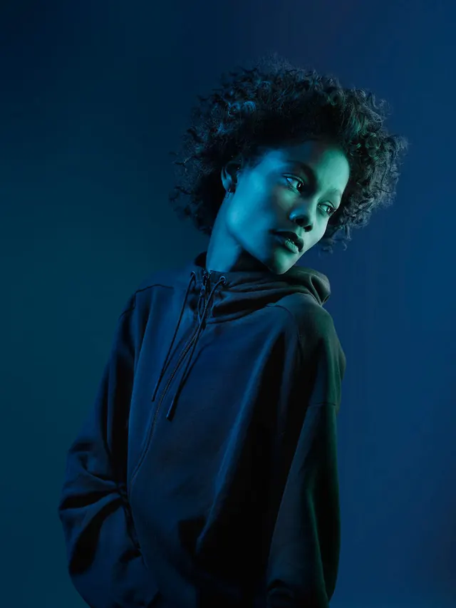 Portrait of a person in blue lighting, dark-mode, photographic, dark