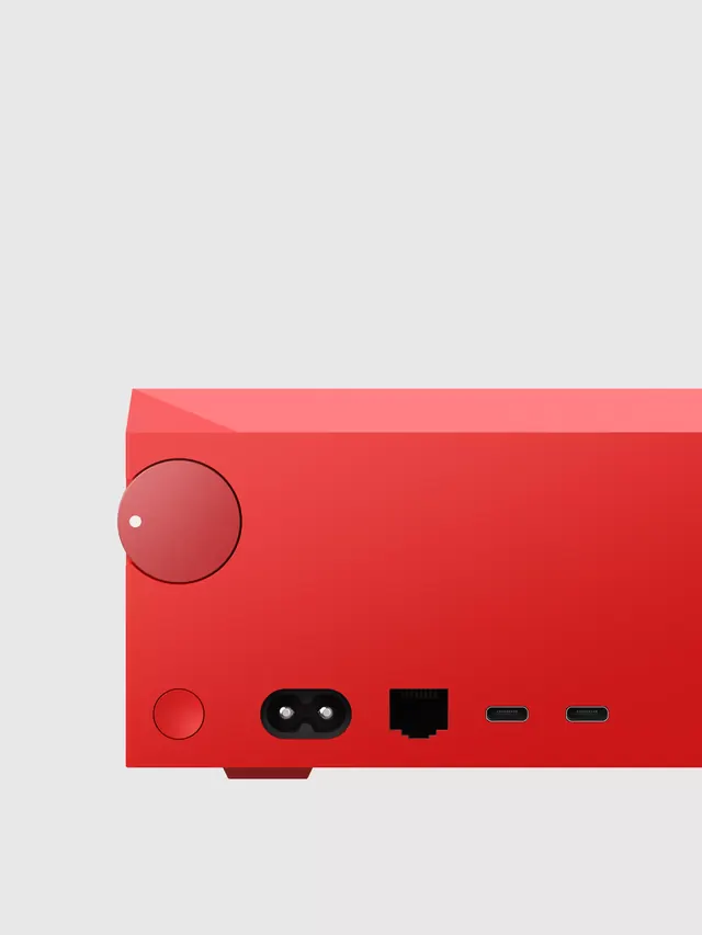 Minimalist electronics product render: coral casing with port details, minimal, flat, vibrant