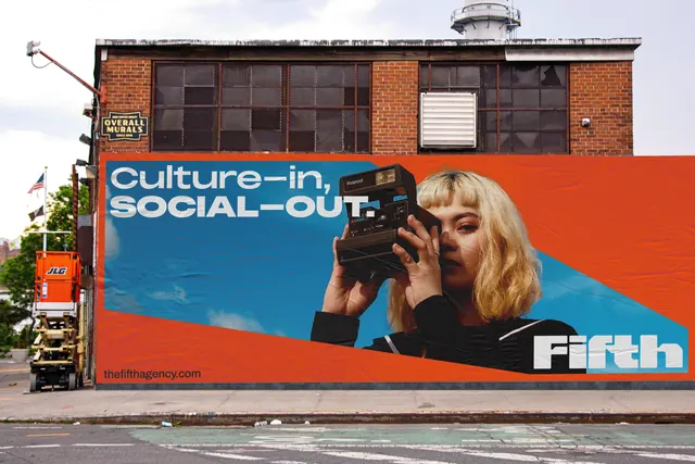 Urban billboard with color-block portrait and sans-serif tagline, photographic, maximalist, warm