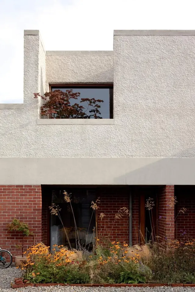Architectural facade with stucco and brick contrast, minimal, geometric, light
