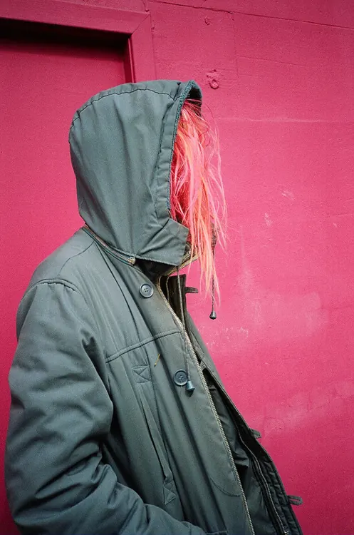 Hooded Figure in Pink and Grey, photographic, minimal, high-contrast