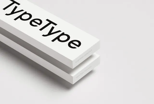 TypeType logotype on stacked white paper specimens, minimal, swiss, light
