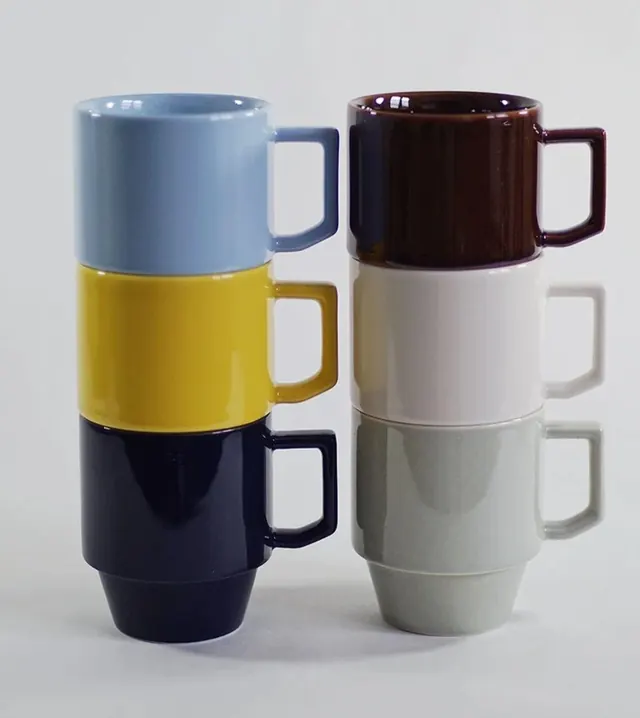 Stacked ceramic mugs in color-blocked sections, minimal, flat, light
