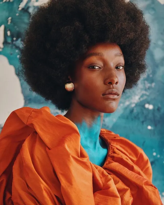 Portrait of a Woman in Textured Garments, photographic, vibrant