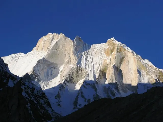 Alpine peak under clear blue sky, photographic, light
