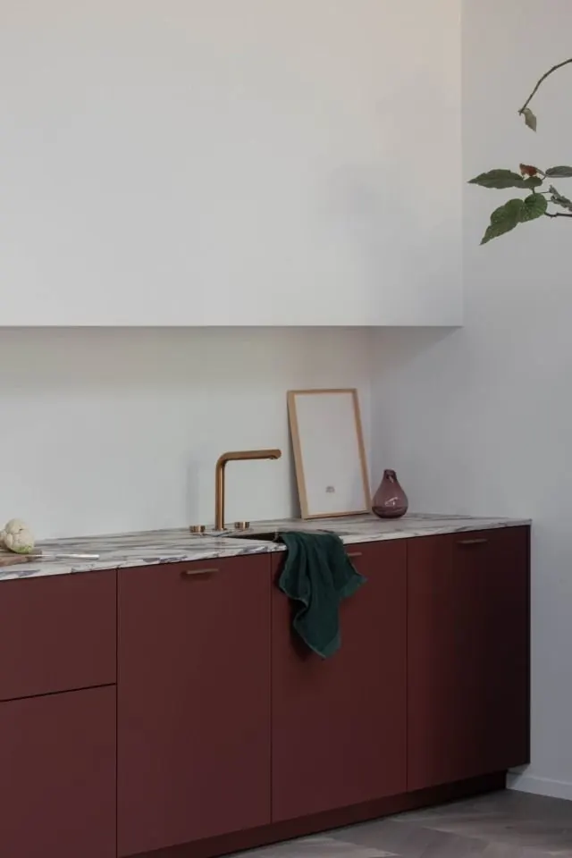 Minimalist kitchen cabinetry in burgundy and marble, minimal, organic, light