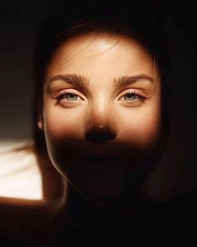 Close-up Portrait with Dramatic Lighting, photographic, minimal, dark