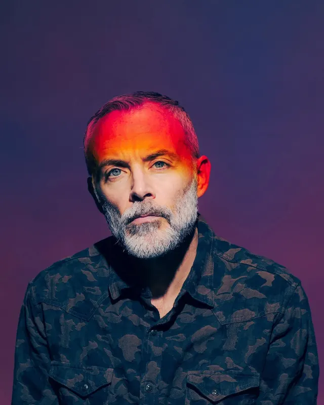 Portrait of a man with vibrant hair, photographic, high-contrast