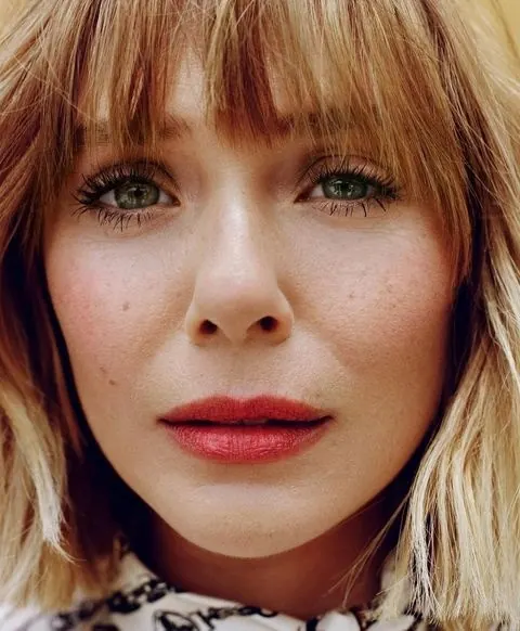 Portrait of a woman with blonde bangs, photographic, organic, warm