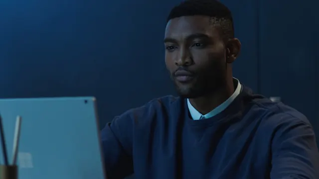 Person using laptop in dark environment, dark-mode, photographic, dark