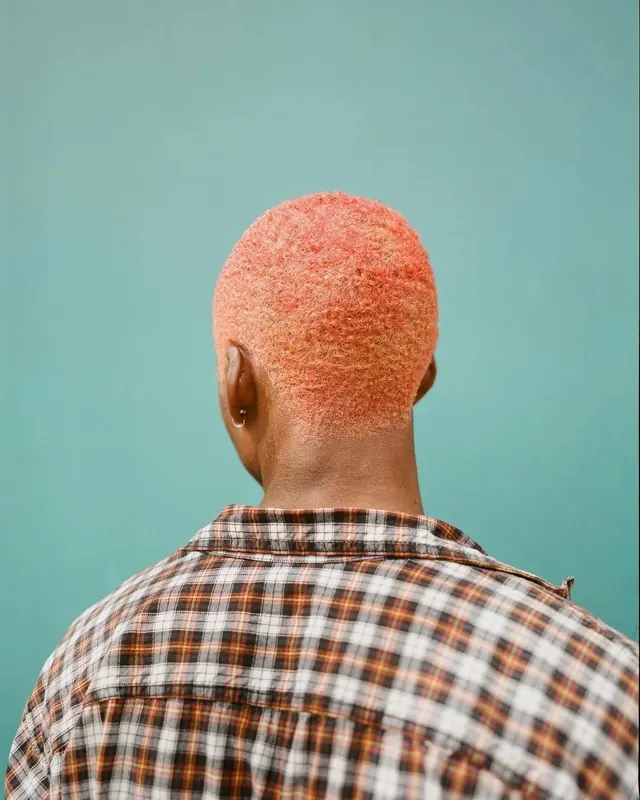 Portrait of a person with orange textured hair, minimal, photographic, vibrant
