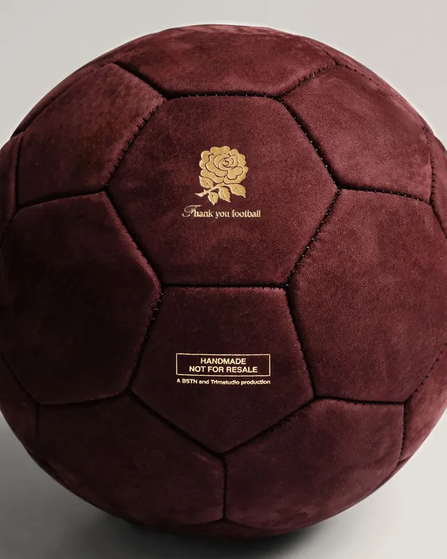 Velvet soccer ball with gold rose emblem, luxury, photographic, dark