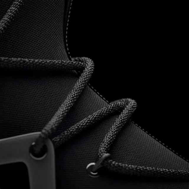 Close-up of black technical rope with metal hardware, photographic, technical, dark