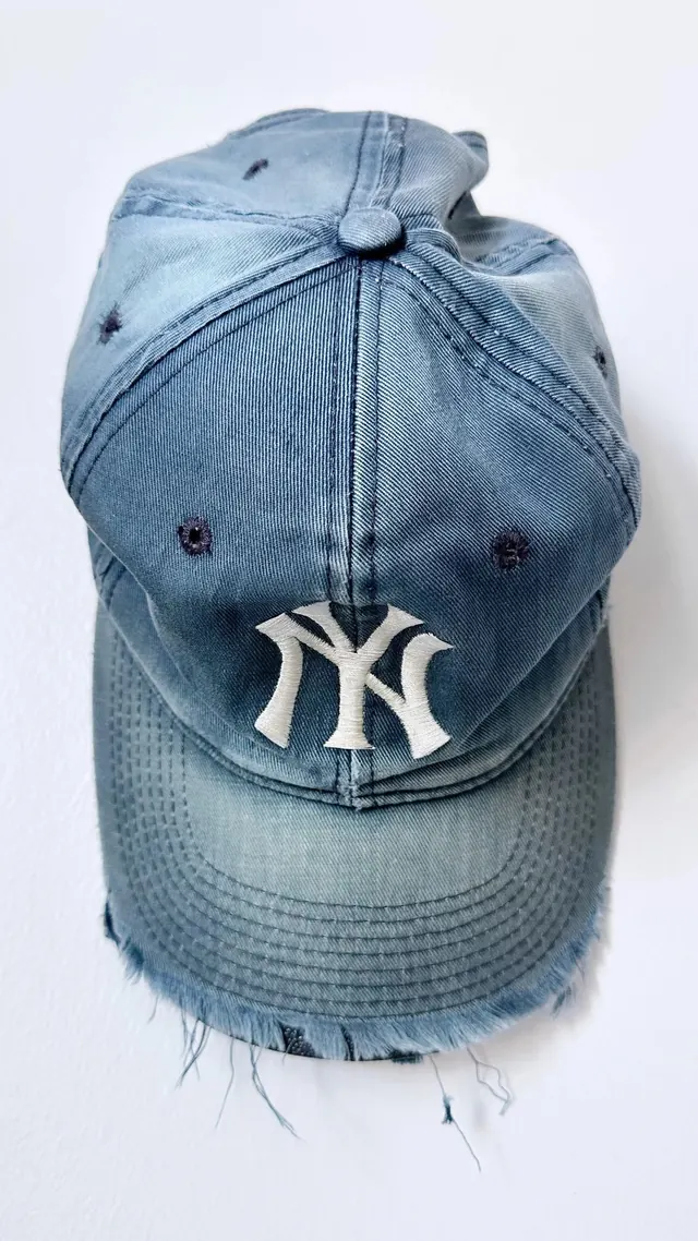 Distressed denim cap with vintage detailing, photographic, minimalist, light