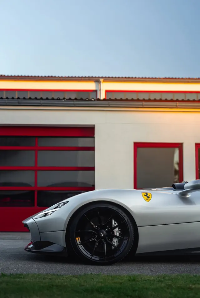 Luxury sports car against red garage doors, photographic, technical, vibrant