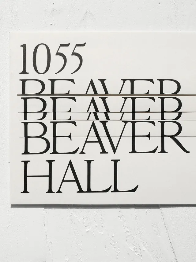 1055 Beaver Hall" wayfinding sign with stacked serif type, swiss, editorial, monochrome