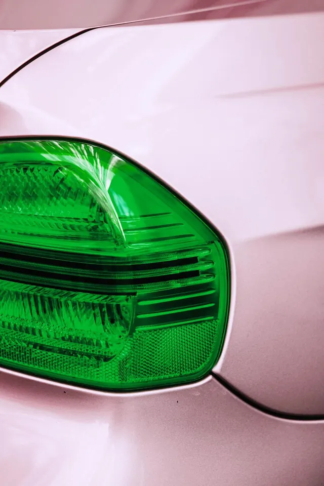 Close-up of Green Vehicle Taillight, photographic, minimal, vibrant