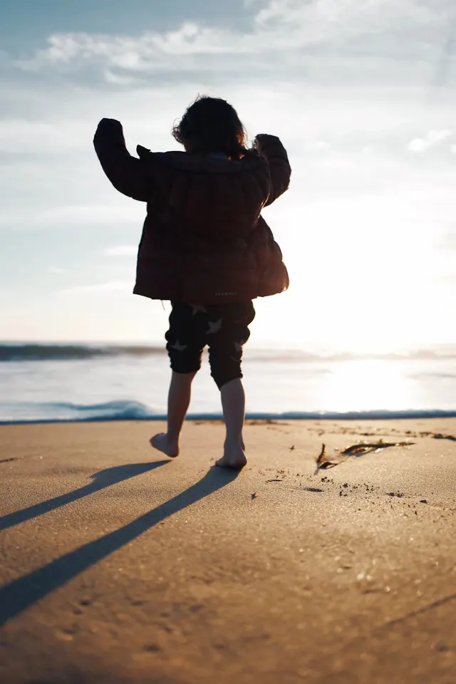 Child on Beach at Sunset, photographic, organic, warm