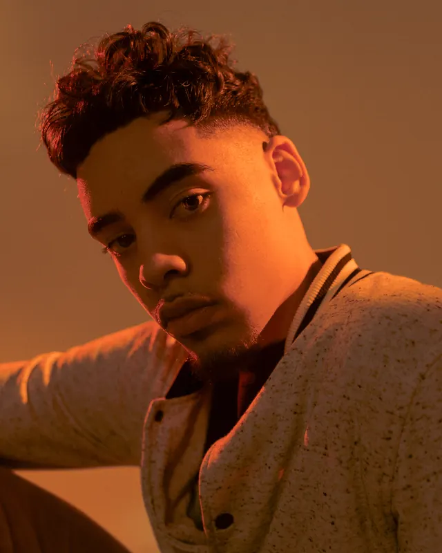 Portrait of a man in warm lighting, photographic, warm
