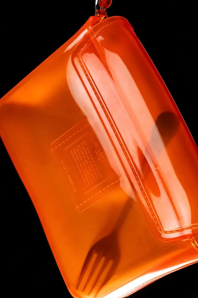 Bright orange liquid bottle product shot, photographic, product-photography, vibrant