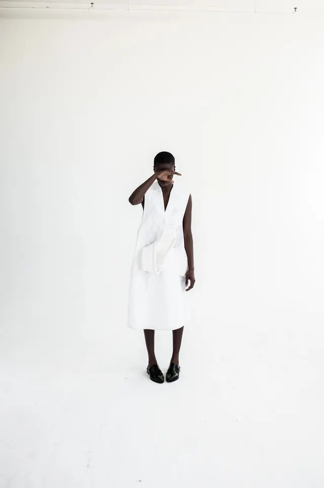 Minimalist portrait in white with cap, photographic, minimal, light