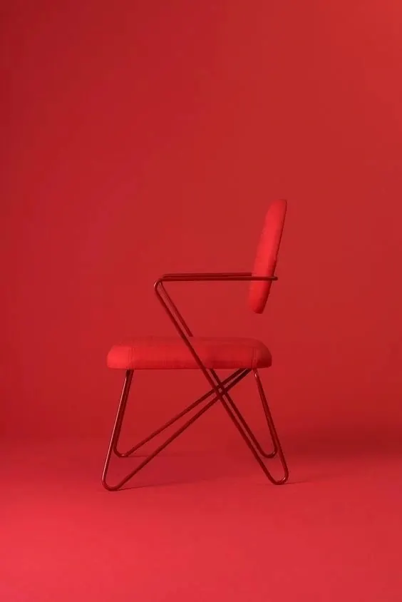 Monochromatic red chair studio shot, photographic, minimal, vibrant