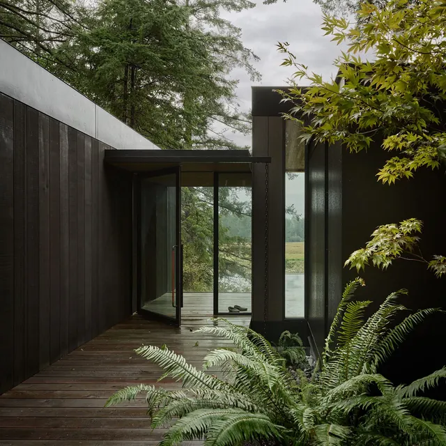 Modern black residential architecture with riverside view, photographic, minimal, dark