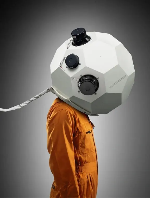 Person wearing geometric sphere headpiece, photographic, conceptual, vibrant