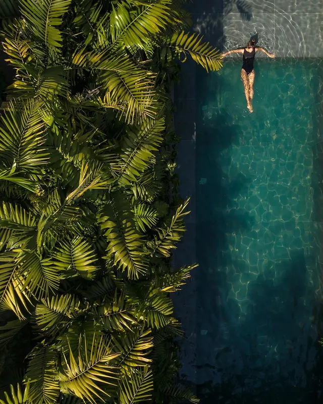 Aerial view of swimmer in turquoise water, photographic, organic, vibrant