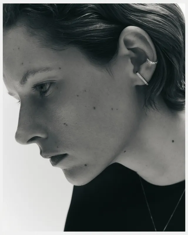 Monochrome ear-jewelry profile portrait, photographic, minimal, monochrome