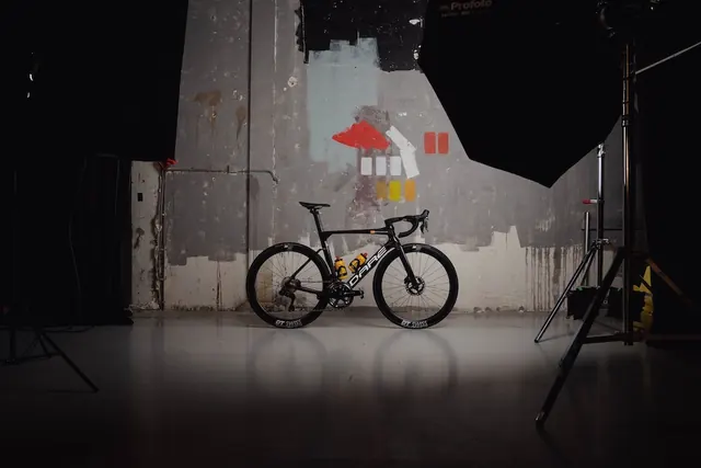 Dark studio product shot of a road bike, dark-mode, minimal, dark