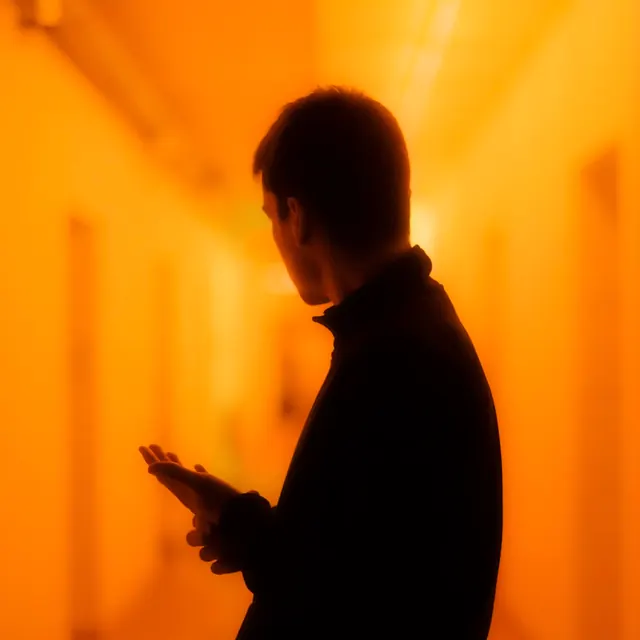 Silhouette figure against golden warm gradient, photographic, minimalist, warm