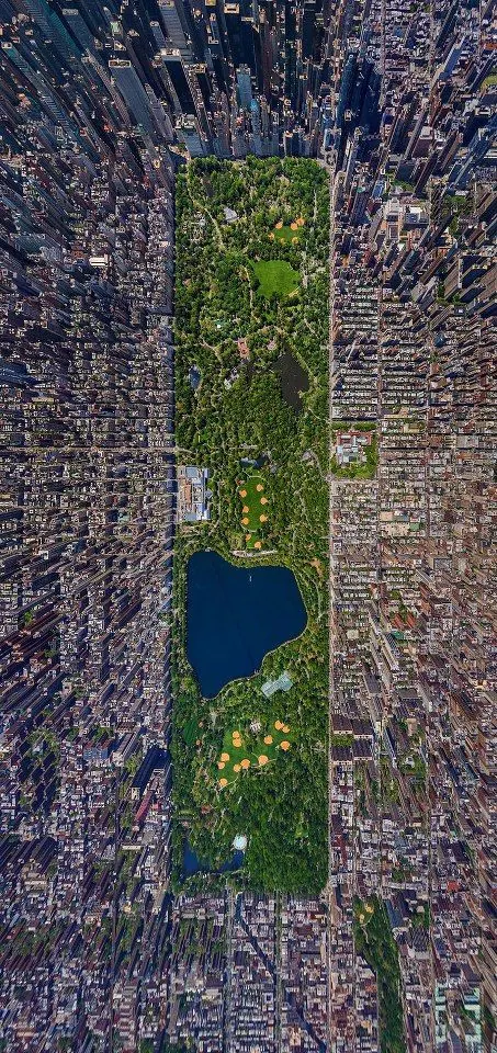 Aerial view of Central Park surrounded by Manhattan urban grid, photographic, dark