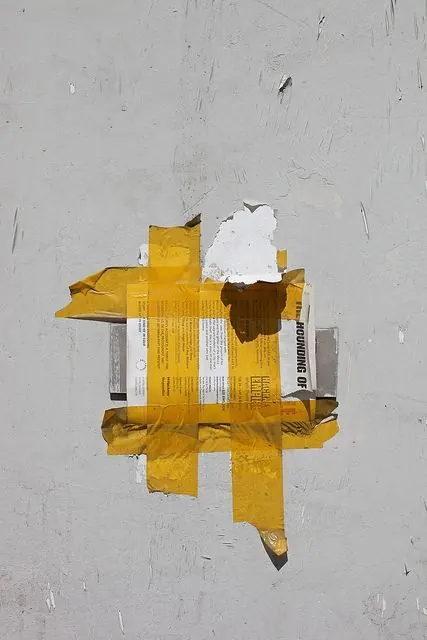 Yellow poster street art with white paper, collage, photographic, vibrant