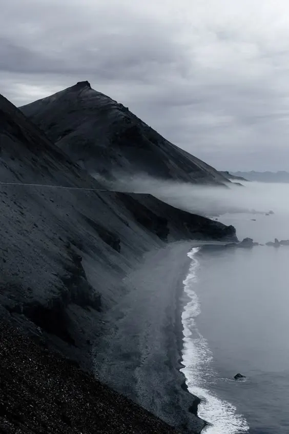 Dark coastal cliffs with fog and surf, photographic, minimal, dark