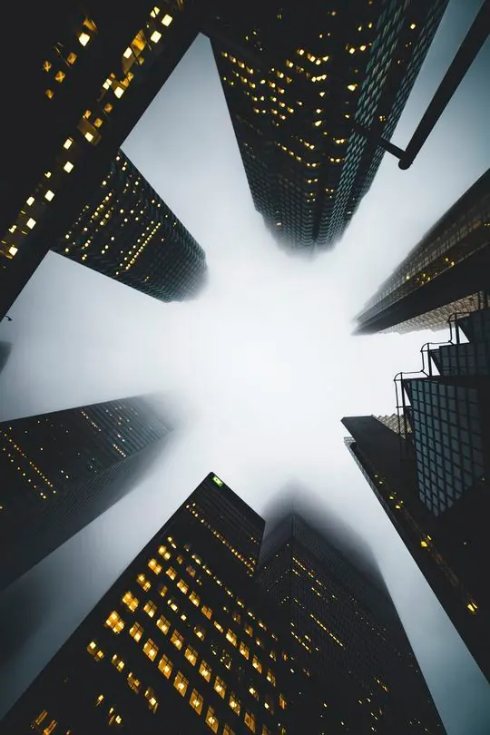 Worm's-eye view of foggy skyscrapers, photographic, geometric, dark