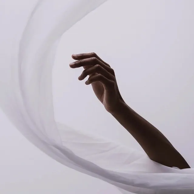 Hand gesture portrait with soft fabric draping, photographic, organic, light