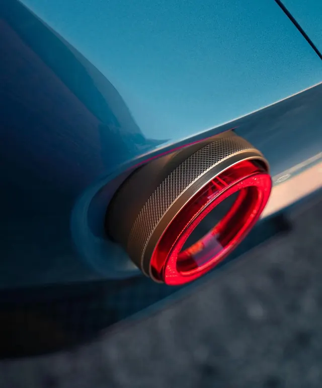 Minimalist car taillight detail shot, photographic, minimal, dark