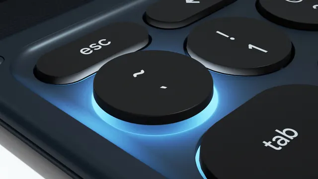 Backlit keyboard buttons with cyan glow accent, technical, minimal, dark