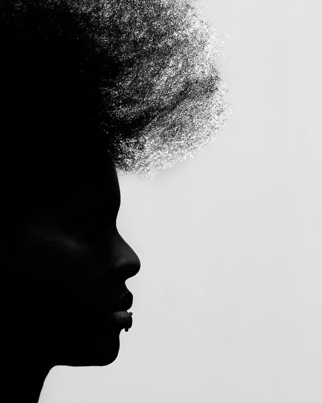 Profile silhouette with dispersing particle effect, minimalist, abstract, monochrome