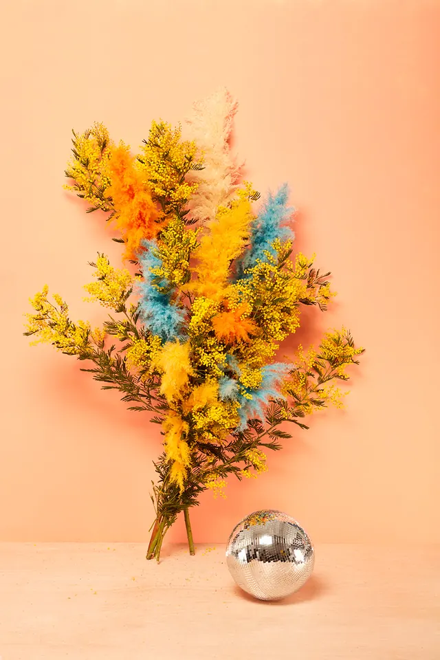 Surreal still life with yellow plants and reflective sphere, illustrated, geometric, vibrant