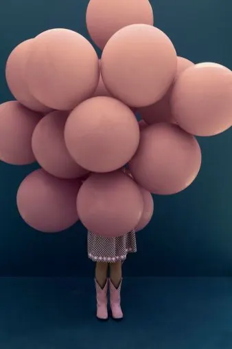 Pink balloon cluster fashion photograph, photographic, surreal, pastel