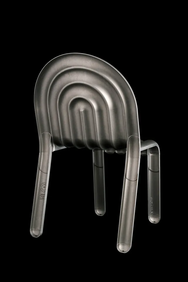Brushed metal sculptural chair back view, minimal, geometric, monochrome