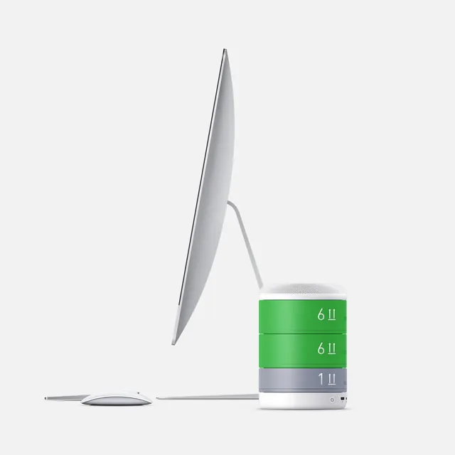 Minimal desktop product setup with modular green speaker, minimal, light