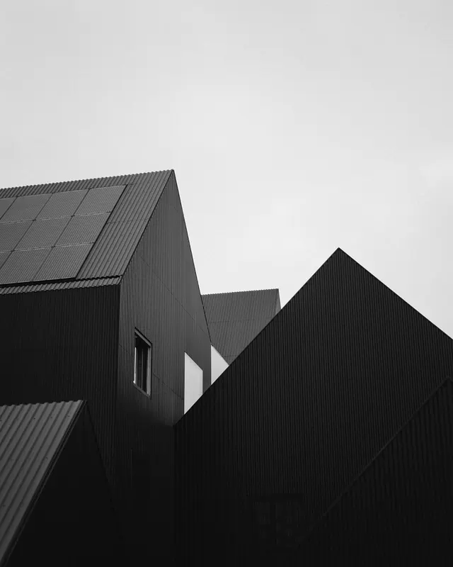 Black corrugated metal buildings, photographic, architectural, dark
