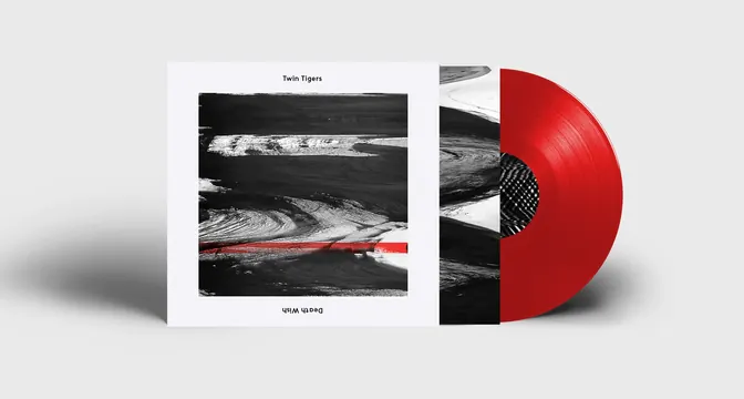 Twin Tigers vinyl album packaging with red record, editorial, minimal, dark