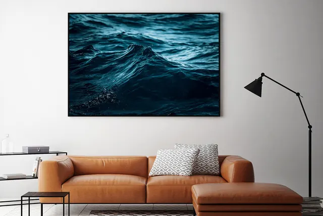 Interior mockup with ocean photography and cognac sofa, photographic, minimal, warm