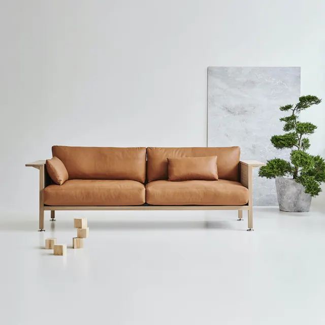 Minimalist leather sofa in neutral interior, minimal, corporate-clean, light