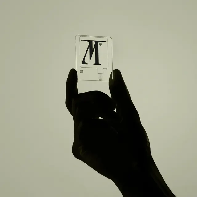 Hand holding vintage computer Macintosh device mockup, photographic, minimal, monochrome